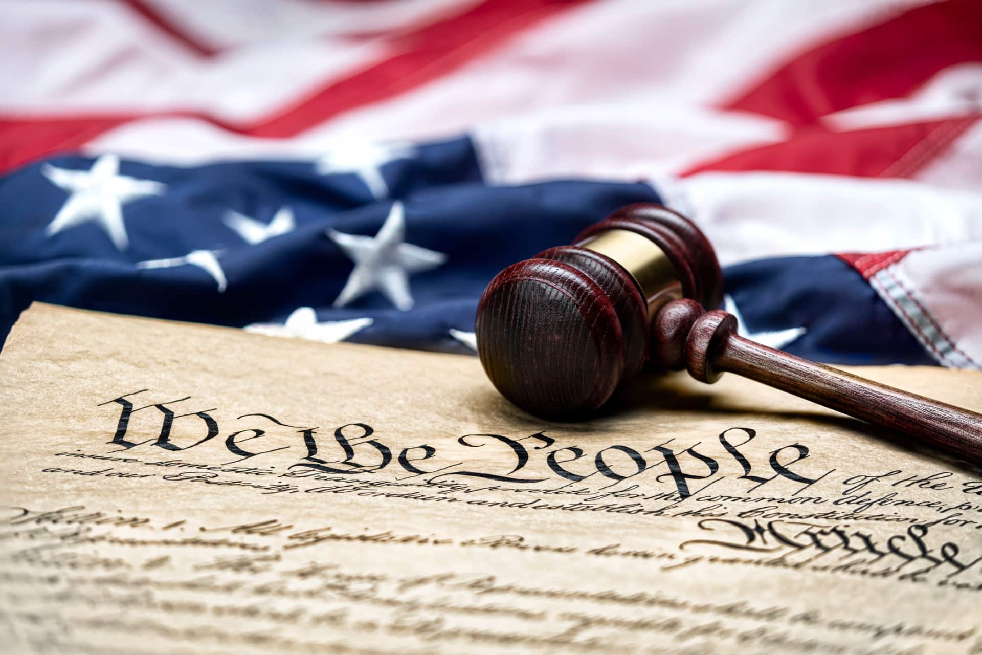 This is a photo of the US Constitution, the American flag, and a gavel.