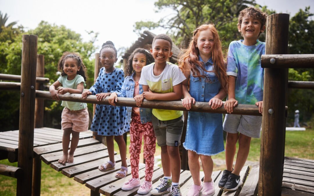 A group of children standing on a bridge