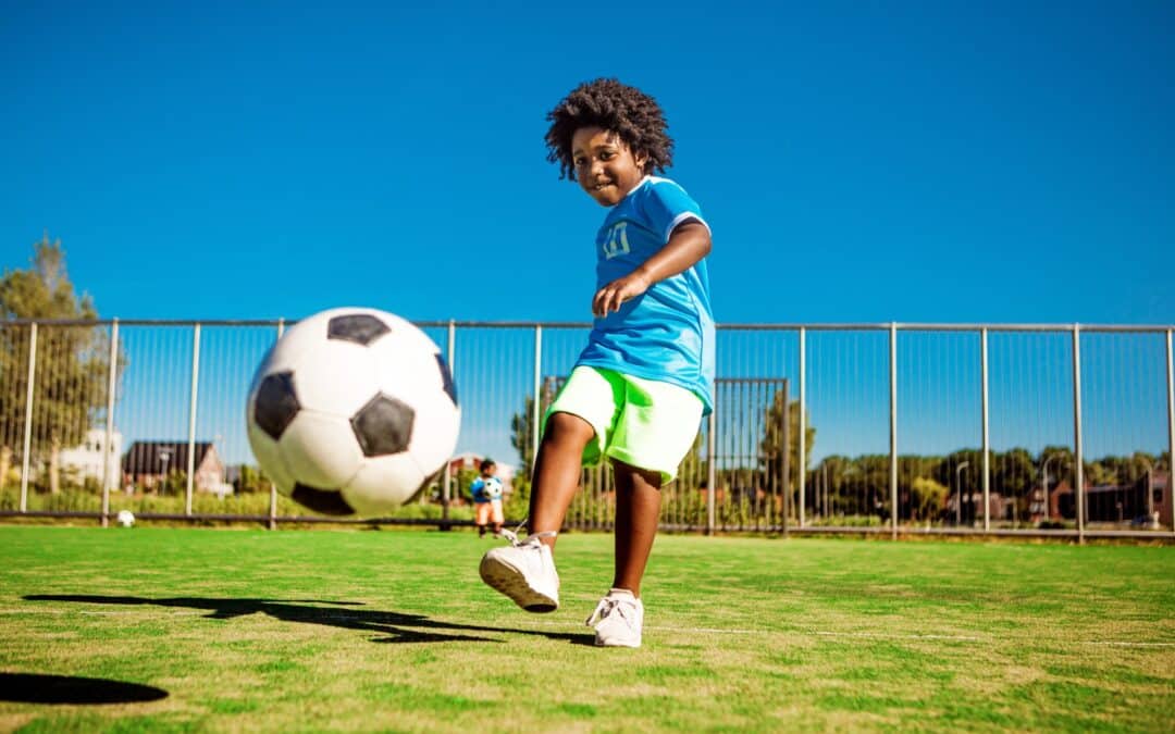 A child kicking a soccer ball