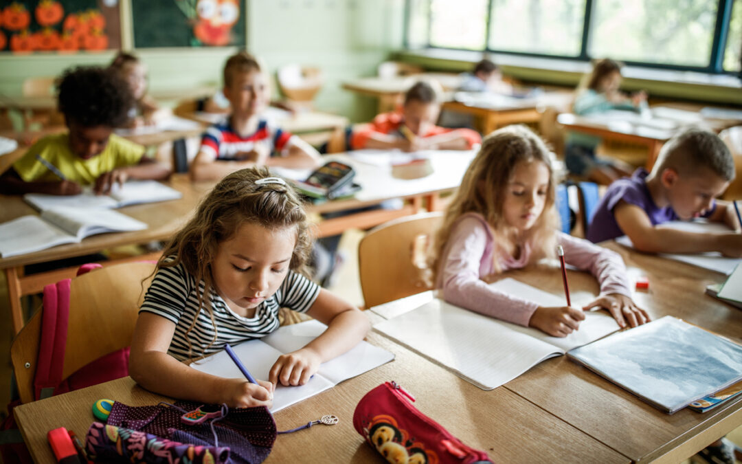 elementary students building writing skills at desks