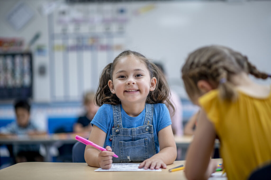 kindergarten-sentence-building-writing-girl-at-desk